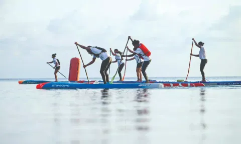 Surfers practicing surfing .