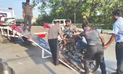 Vehicles that were not parked in designated space being removed. Violators were also fined