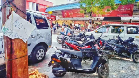 Two-wheelers parked right next to a ‘No Parking’ sign at a local station
