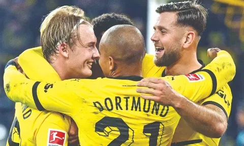 Julian Brandt (L) celebrates his goal with teammates during the match against SV Werder Bremen.