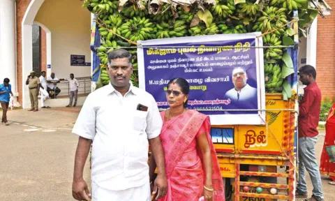 Madhiazhagan and wife Kavitha with truck load of bananas in Thanjavur on Monday