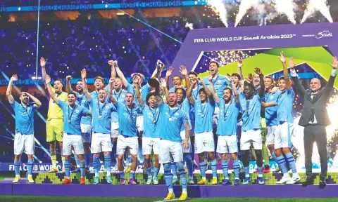 Manchester City team celebrate with their winning trophy at the end of the FIFA Club World Cup 2023 final.