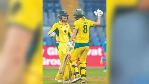 Australian batter Phoebe Litchfield celebrates with Ellyse Perry after her half-century