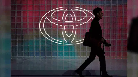 A man walks past a Toyota logo at the Tokyo Motor Show, in Tokyo (Photo/Reuters)