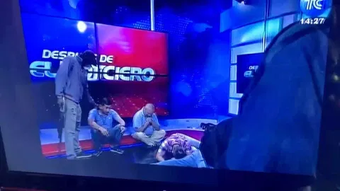&nbsp;Workers lie on the floor as hooded and armed people take over a tv studio of Ecuador's TV station TC (Reuters)