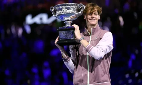 Italy’s Jannik Sinner poses with the Norman Brookes Challenge Cup trophy