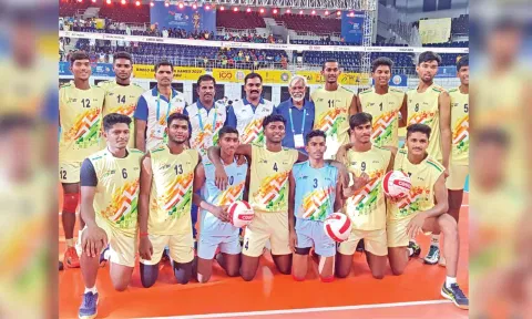 The victorious TN boys volleyball team pose after the final match