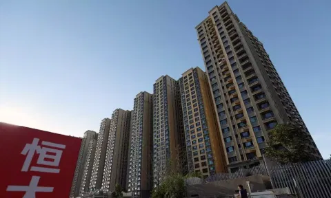 An Evergrande sign is seen near residential buildings at an Evergrande residential complex in Beijing