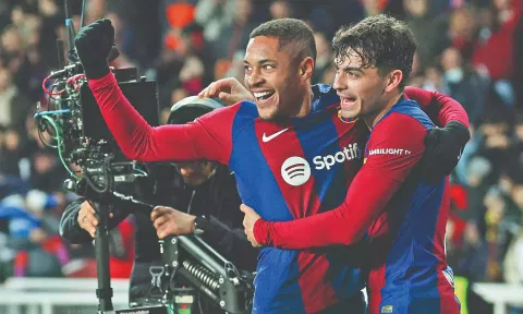 Vitor Roque (L) celebrates his first goal for Barcelona with Pedri