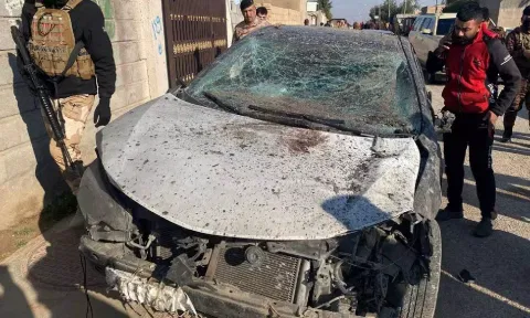 Security forces inspect a damaged car at the site of a US airstrike&nbsp;