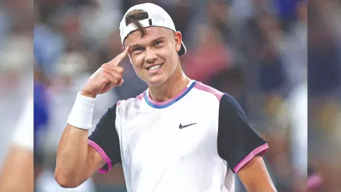 Holger Rune reacts after winning a set against Taylor Fritz