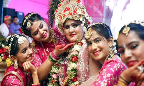 Artists dressed in traditional attire pose for a picture during the Phagotsav (three-day Holi celebration), at Govinddevji temple in Jaipur on Thursday. (ANI)