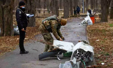 Police officers inspect a part of a Russian Kh-55 cruise missile, intercepted during a missile strike (Reuters)