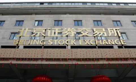 The sign of Beijing Stock Exchange is seen at its entrance during an organised media tour, in Beijing (Reuters)