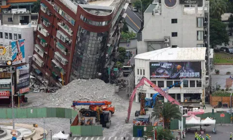 People take part in a ceremony ahead of the demolition of a damaged building, following the earthquake, in Hualien (Reuters)