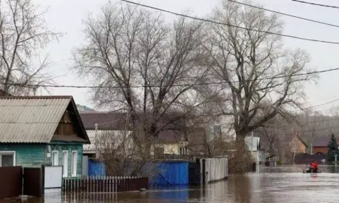 People move past in an inflatable boat in a flooded residential area in the city of Orenburg, Russia (Reuters)&nbsp;