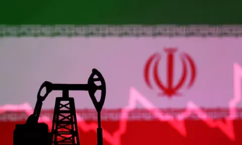 Iranian flag with stock graph and an oil pump jack miniature model are seen in this illustration (Reuters)&nbsp;