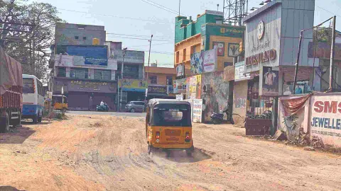 The muddy Rose Mahal Road in Tiruvallur