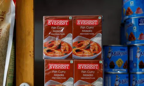 Boxes of Everest fish curry masala are stacked on the shelf of a shop at a market (Reuters)&nbsp;