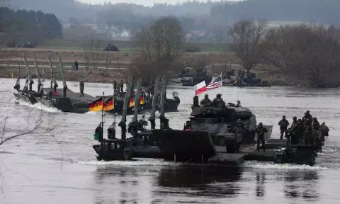 German soldiers transport U.S. soldiers in an M2 Bradley infantry fighting vehicle (Reuters)