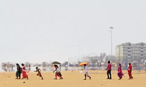 People walking at beach under hot sun (Photo: Justin George)