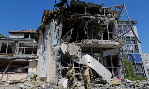 Russian military investigators work in a restaurant building hit by recent shelling (Reuters)