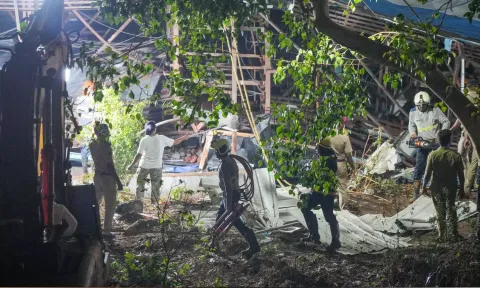 Rescue work underway after a huge billboard collapsed on a petrol pump due to strong winds and rain (PTI)