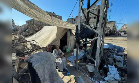 Displaced Palestinians, who fled their house due to Israel's military offensive, sit outside their tent, in Rafah, in the southern Gaza Strip (Reuters)&nbsp;