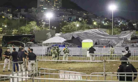 Security forces stand around a stage that collapsed due to gust of wind (AP)