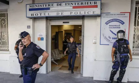 &nbsp;Police wait for the arrival of French President Emmanuel Macron at the central police station in Noumea