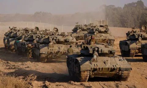 An Israeli soldier stands in a tank, amid the ongoing conflict between Israel and Hamas, near the Israel-Gaza border, in Israel (Reuters)