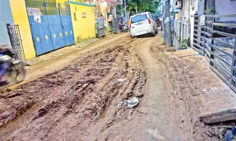 A four-wheeler stuck in the muddy road on 12th street of Balaji Nagar