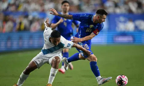 Lionel Messi gets past defender Jose Ardon during the match