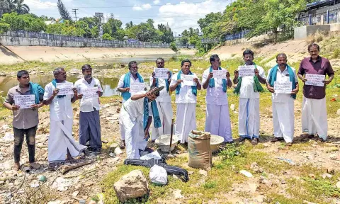 Farmers protest standing in a dry GA canal in Thanjavur