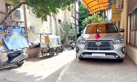A car with DMK party flag parked on the illegally built ramp