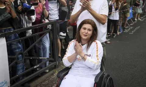 Press agency photographer Christina Assi arrives for the Olympic torch relay at the 2024 Summer Olympics (AP)