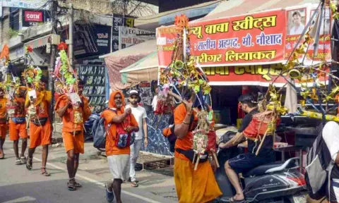 Kanwariyas walk past a shop on which banners with shopkeeper's name was put up on Kanwar Marg (PTI)
Read more at: https://www.onmanorama.com/news/india/2024/07/22/sc-imposes-stay-on-order-asking-eateries-to-display-name-of-owners.html