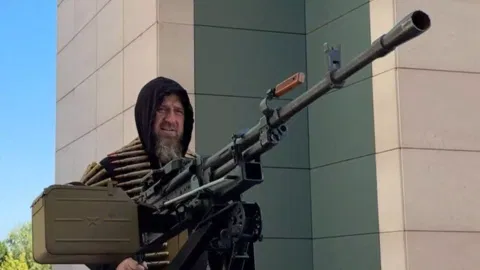 Kadyrov in the Tesla Cybertruck with a machine gun&nbsp; (AP)