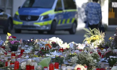 Flowers and candles are laid near the scene of a deadly knife attack during a festival, in Solingen, Germany (AP)