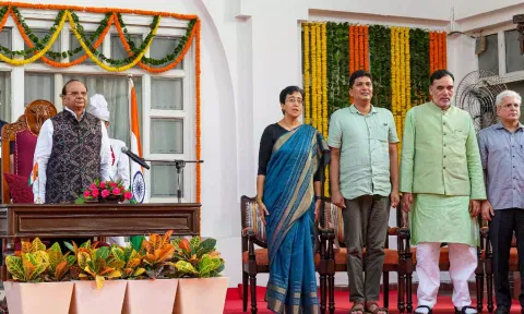 Delhi Lt. Governor V.K. Saxena with CM-designate Atishi, and AAP leaders&nbsp; during her swearing-in ceremony, at Raj Bhavan, in New Delhi (PTI)