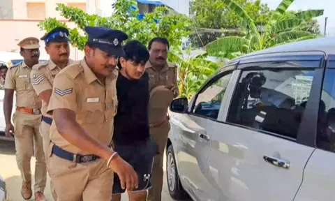 Police personnel take a member of a gang suspected to have been involved in ATM heist in Kerala's Thrissur (Photo: PTI)