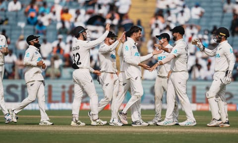 &nbsp;New Zealand's Mitchell Santner celebrates with teammates after taking the wicket of India's Ravichandran Ashwin (PTI)