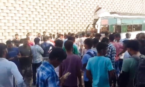 People gather near the mangled remains of a bus after it crashed into the wing wall of a flyover, leaving at least ten people dead and 36 injured, in Rajasthan's Sikar district, Tuesday, Oct. 29, 2024.&nbsp;