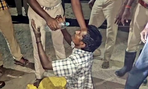 A police officer offers water to the man after bringing him down&nbsp;