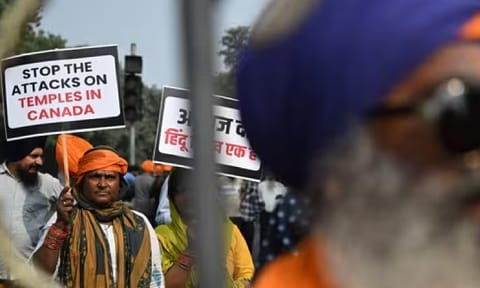 A Nihang Sikh warrior holds a placard as he takes part in a protest near the Canadian embassy in New Delhi against the recent attack on a Hindu temple in the city of Brampton (AFP)&nbsp;