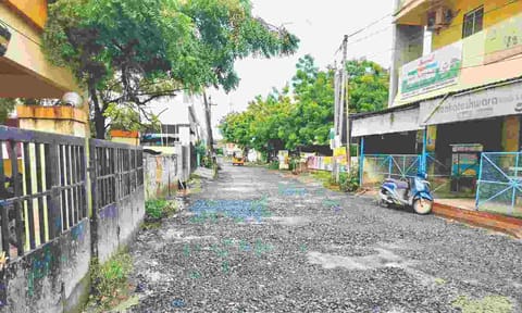The road in Noombal has an uneven surface and is filled with potholes