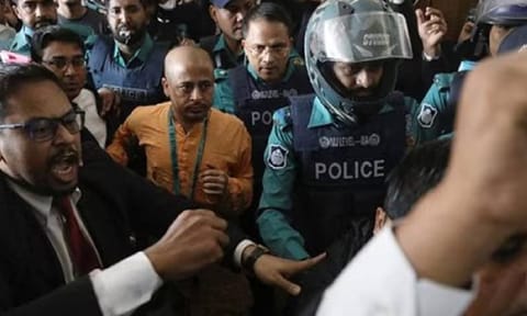 Chinmoy Krishna Das, a Hindu leader associated with the ISKCON, who faces several charges, is escorted by the police at the Chattogram Metropolitan Magistrate Court, in Chattogram (Reuters)&nbsp;