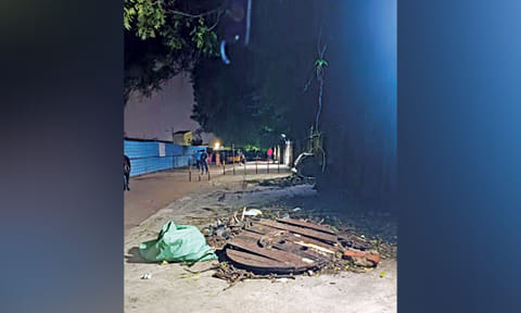 Wood waste lying haphazardly on the pedestrian pathway along the railway station