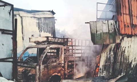The mini van and a car (not in photo) parked inside the premises were destroyed in fire on Friday