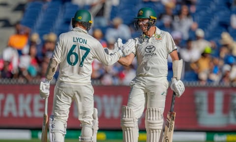 Australia's Nathan Lyon, left, and Scott Boland shake hands during play on the day four of the fourth cricket test between Australia and India (PTI)&nbsp;
